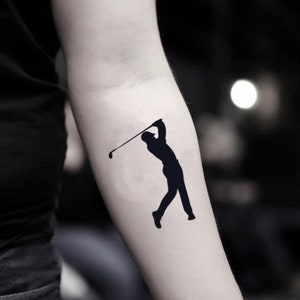 May include: A black silhouette of a golfer swinging a club.