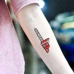 May include: A temporary tattoo of a red chainsaw with the word "Chainsaw" written on it.