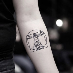 May include: A black and white temporary tattoo of a man in a square and circle, reminiscent of the Vitruvian Man.