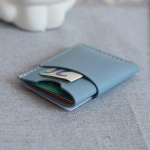 The compact leather ID card holder is on the table.
