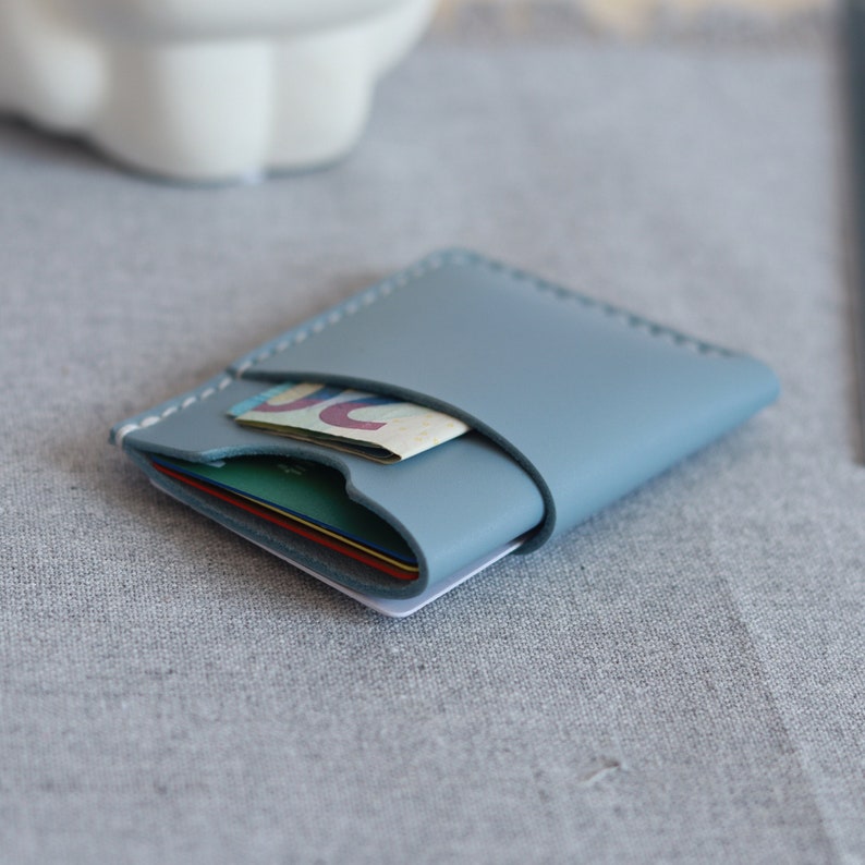 The compact leather ID card holder is on the table.