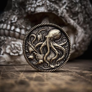 May include: A detailed, antique-style bronze coin featuring an octopus wrapped around a ship. The coin has a rope-like border and is set against a blurred background of a skull. The coin's design is intricate and detailed.