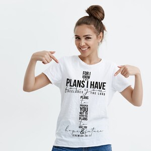 May include: White t-shirt with a black graphic print that reads "For I know the plans I have for you, declares the Lord, plans to prosper you and not to harm you, plans to give you hope and a future." Jeremiah 29:11