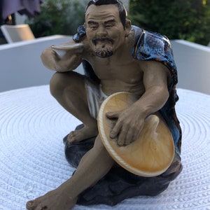 Vintage Chinese glazed ceramic mudman with hat and blue coat