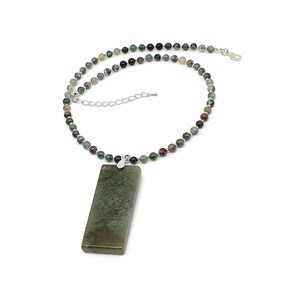 May include: A necklace featuring a large, rectangular, mottled green stone pendant suspended from a strand of small, multi-colored, speckled round beads. The necklace includes a silver-toned metal clasp and an adjustable chain extension.