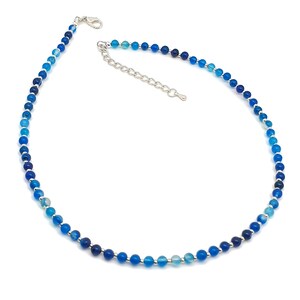 Beaded blue Agate necklace, made with small round gemstone beads interspaced with tiny silver plated glass seed beads, strung on flexible silicon plated steel beading wire. Finished with silver plated brass lobster claw clasp and extension chain.