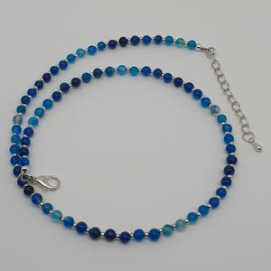 Beaded blue Agate necklace, made with small round gemstone beads interspaced with tiny silver plated glass seed beads, strung on flexible silicon plated steel beading wire. Finished with silver plated brass lobster claw clasp and extension chain.