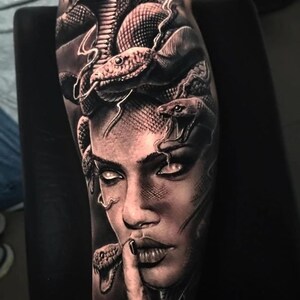 May include: Black and white tattoo of a woman's face with snakes for hair. The woman's eyes are white and she has a serious expression. The snakes are realistic and detailed.