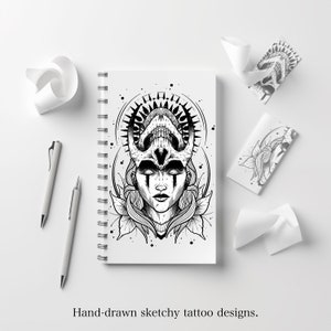 May include: Black and white line art drawing of a woman's face with a skull crown. The woman has long hair and is wearing a crown with horns and a skull. The drawing is in a sketchbook with a spiral binding.