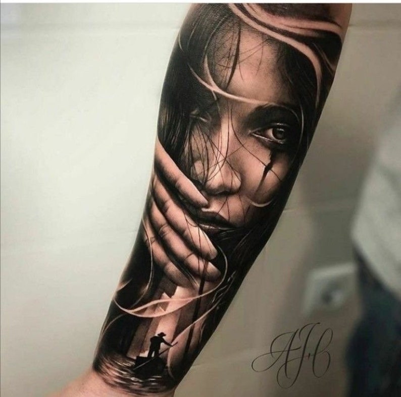 May include: Black and grey realistic tattoo of a woman's face with her hand covering part of her face. The tattoo is on a person's arm. A small silhouette of a person in a boat is visible in the background.