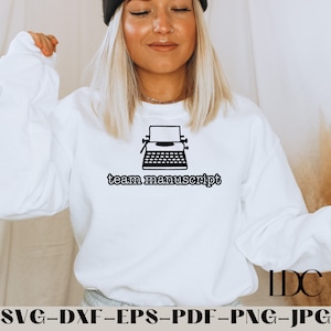 May include: White sweatshirt with a black typewriter graphic and the text "team manuscript".