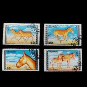 May include: Four rectangular postage stamps from Mongolia featuring illustrations of Equus hemionus in a desert landscape. Each stamp displays the text Mongolia, the value 60, and the scientific name Equus hemionus, with black postmarks over the edges.