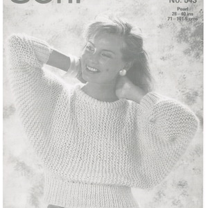 May include: A black and white photo of a woman wearing a knitted sweater. The sweater is a loose fit and has a ribbed hem. The woman is smiling and has her hair pulled back. The photo is from a knitting pattern book and includes the text "No. 543 Pearl 28-40 ins 71-101.5 cms".