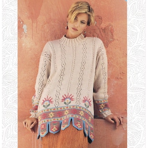 May include: A beige knitted sweater with a high collar and long sleeves. The sweater has a decorative floral pattern in red, blue, and yellow along the hem and cuffs. The text "JAEGER" is visible at the top. The size is one size to fit 86-102 cm.