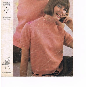 May include: Vintage knitting pattern cover featuring two women wearing short-sleeved, light coral-colored sweaters. The pattern is for double knitting, 4-ply yarn, and fits bust sizes 30 to 40 inches. The Emu brand logo is visible.
