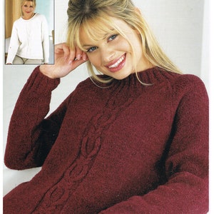 May include: A burgundy sweater with a cable knit design. The sweater is shown on a model with blonde hair. The sweater is 32-42 inches in length.