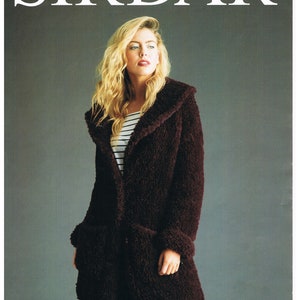 May include: A woman wearing a burgundy fuzzy coat with a large collar and a striped shirt underneath. The coat has a large pocket on the front. The background is a light gray. The text "Sirdar" is at the top of the image and "Alpine 81/86 - 132/137 cm" is at the bottom.