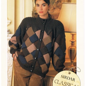 May include: A button-up, patchwork-style cardigan in shades of brown, blue, and pink. The sweater has a ribbed collar and cuffs. The tag reads "SIRDAR CLASSICAL Pure Wool Double Crepe". The model is wearing brown corduroy pants.
