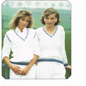 May include: Two women wearing white knit sweaters with blue trim. The sweaters are a v-neck style. The sweaters are from a knitting pattern by Peter Gregory, Double Knitting 565, sizes 76-102 cm (30-40 inches).