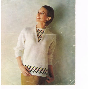 May include: A vintage knitting pattern featuring a white sweater with a colorful geometric design. The pattern is for sizes 34-38 inches bust and is titled "Patons Double Quick Knitting".