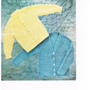 May include: A knitting pattern for two children's cardigans. One cardigan is yellow and the other is blue. The pattern is from Lee Target and is for sizes 18 inches to 26 inches chest.