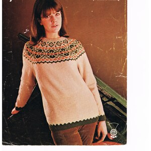 May include: Vintage knitting pattern cover featuring a woman wearing a light pink sweater with a patterned yoke in green, orange, and black. The sweater has green trim. The text "Templeton's" is at the top, with "1418" and other text below.