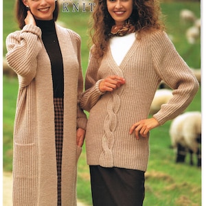 May include: Two women wearing long, beige knit cardigans. The cardigan on the left has pockets and is open in the front. The cardigan on the right has a cable knit pattern and is buttoned up. Both women are wearing black skirts.