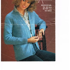 May include: A blue knitted cardigan with a cable knit pattern and a button closure. The cardigan is shown on a model with a white blouse underneath. The pattern number is 3510 and the yarn is Zephyr D.K. 32-42 inch, 81-107 cms, six sizes.