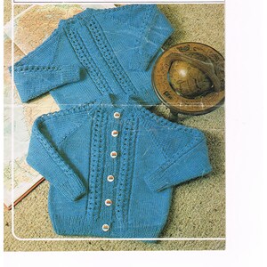 May include: A knitting pattern for a blue cardigan with button closures. The pattern is for sizes 20-26 inches chest and is called "Studley" and is number 922.