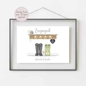 May include: A framed print featuring the word Engaged, a wooden shelf with heart cutouts, black and green wellington boots, two champagne glasses, and a heart-shaped tag with 14th February 2023. The names Daniel & Sadie appear below the boots.