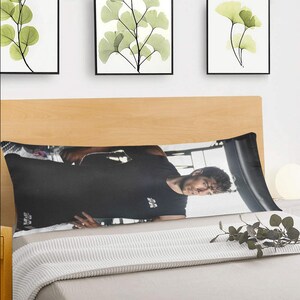 May include: A black and white body pillow featuring a man in a black shirt with the text "MR. BEAST" on it.