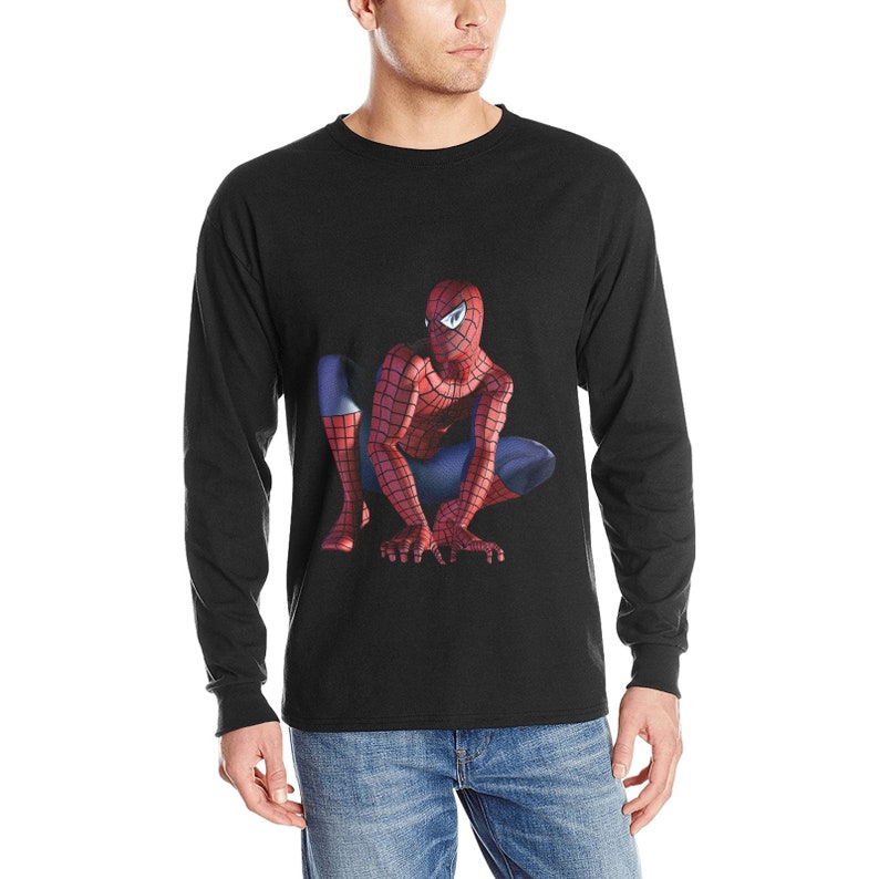 May include: Black long-sleeve t-shirt with a graphic of Spiderman crouching and looking to the left.