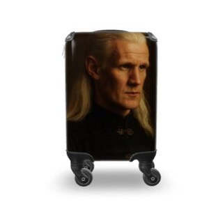 May include: A black travel suitcase with a portrait of a man with long blonde hair and a serious expression. The suitcase has a black frame and four black wheels, suitable for travel.