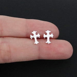 May include: A pair of silver cross stud earrings. The earrings are small and delicate, and they would make a great gift for someone special.