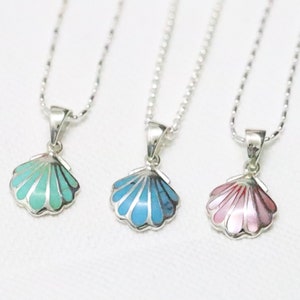 May include: Three silver necklaces with shell pendants. The shells are decorated with turquoise, blue, and pink enamel.