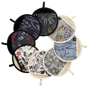 May include: Eight round pot holders with different floral patterns. The pot holders are made of a soft, absorbent material and have a black trim.