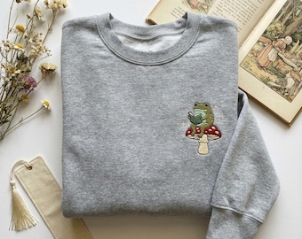 Embroidered Frog on Mushroom Sweatshirt, Cute Cottagecore Crewneck, Frog Reading Book Gift, Nature Aesthetic Tshirt