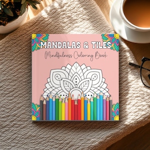 May include: A pink coloring book titled "MANDALAS & TILES Mindfulness Coloring Book" featuring a mandala design and a row of coloured pencils. The book rests on a textured beige surface, with a coffee cup and a plant visible in the background.