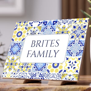 May include: A white sign with a blue and yellow patterned border. The sign says "Brites Family" in blue text.