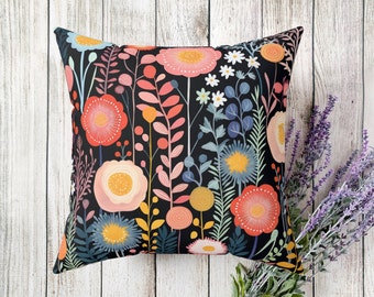 Könnte beinhalten: Ein schwarzes Kissen mit einem floralen Muster mit rosa, roten, gelben und blauen Blumen auf schwarzem Hintergrund.
