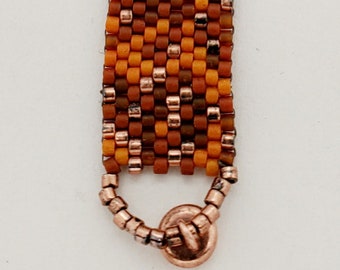 Mostly Random Bracelet of orange, bronze, brick red, and copper Delica beads in peyote stitch, magnetic closure