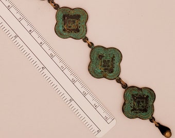Green & Bronze Quatrefoil Bracelet has 6 medallions with green patina, likely brass base, antique brass ball joint clasp