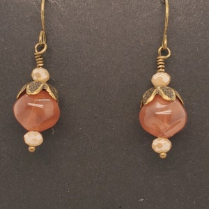 Mauve Bead Earrings, large translucent mauve glass bead with indentations, topped with antique brass tone beadcap, small cream rondelles