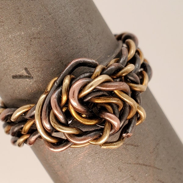 ring of twisted copper and brass wires ending with swirl