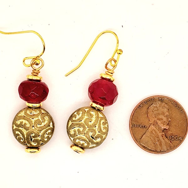 Cranberry Red & Gold Earrings, large faceted rondelles atop large lentil bead with depressed whorl design, donut spacers, ball end ear wires