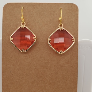 Square Red Crystal Earrings faceted surface in channel setting with prongs, double=sided, gold tone ear wires