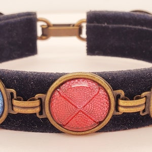 Criss Cross Taillight Cabochon Bracelet, cabs are red, blue, and purple, 7 altogether, fold over clasp, antique brass tone settings