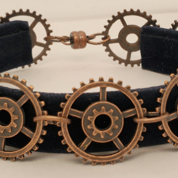 Antique Copper Gear Bracelet with 9 gears, all the same, 5 spokes, center detail, cogs along edge, magnetic clasp