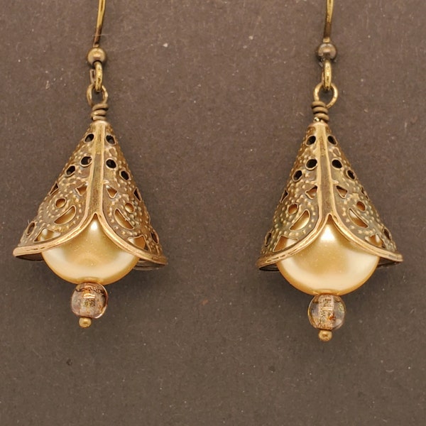 Cone & Coin Pearl Earrings have a pierced and beaded antique brass beadcap over Swarovski golden coin pearl and clear golden bead, ear wires