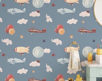 May include: A blue wallpaper with a repeating pattern of airplanes, hot air balloons, clouds, stars, and elephants. The wallpaper is in a bathroom setting with a sink, mirror, and towel rack.